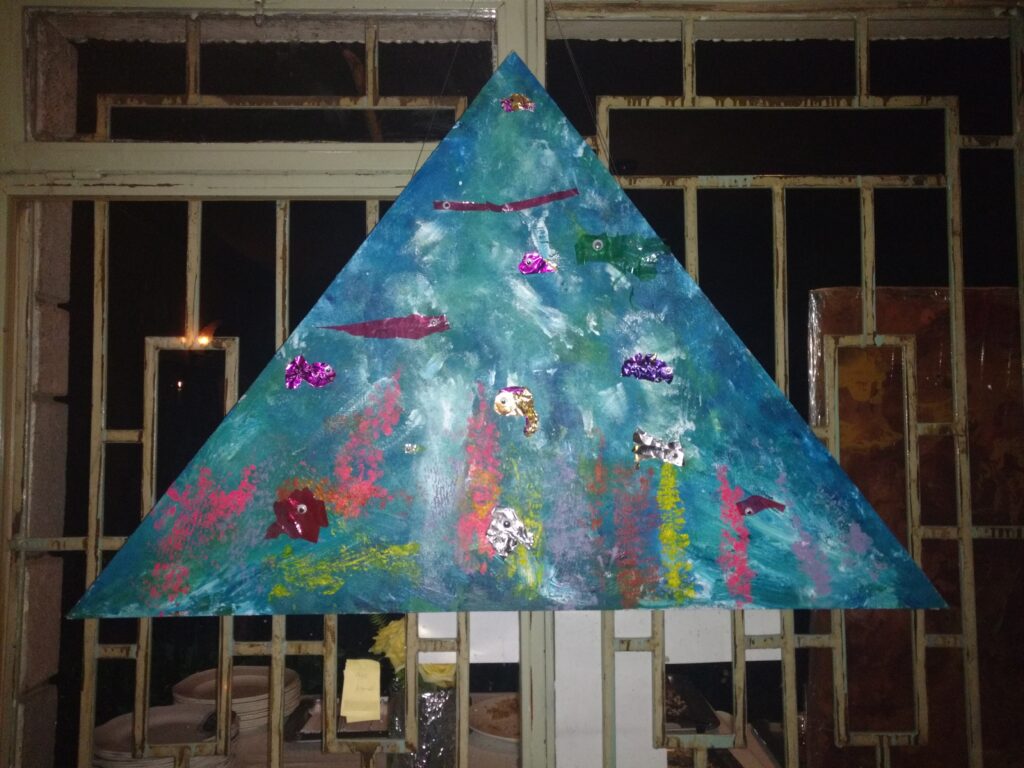 This Under The Sea collaborative canvas work was done by 2 year old's, on wooden triangle canvas with acrylic paint (2017).