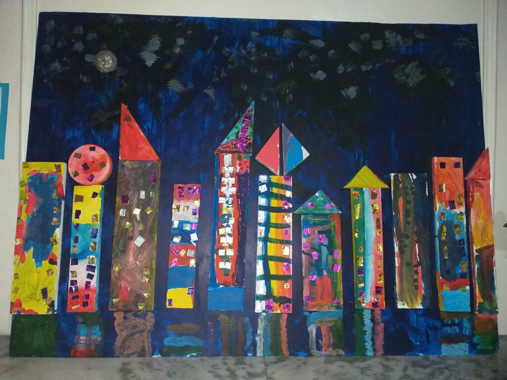 3D mixed media wood canvas is done by 4-year-old kindergarteners back in 2019. The art piece was named City Nights by my students.